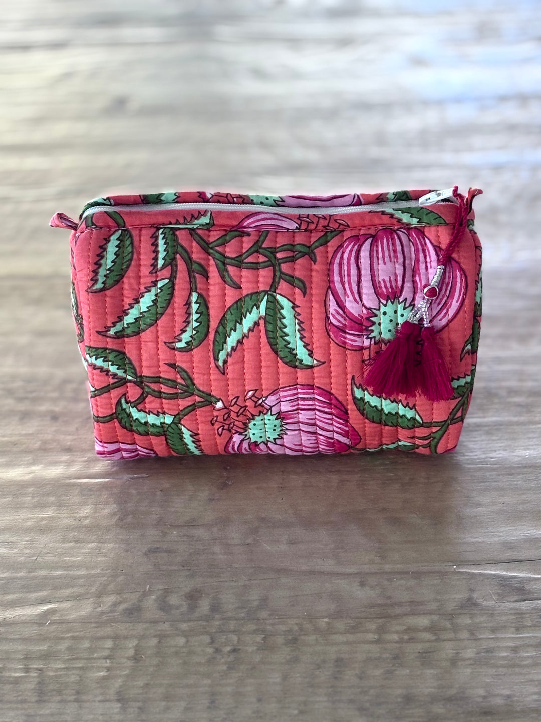Floral patterned pouch on a wooden surface