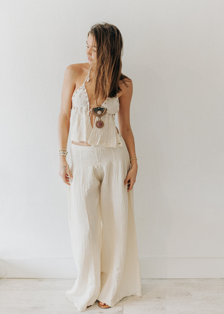 Woman wearing a white outfit with a plain background