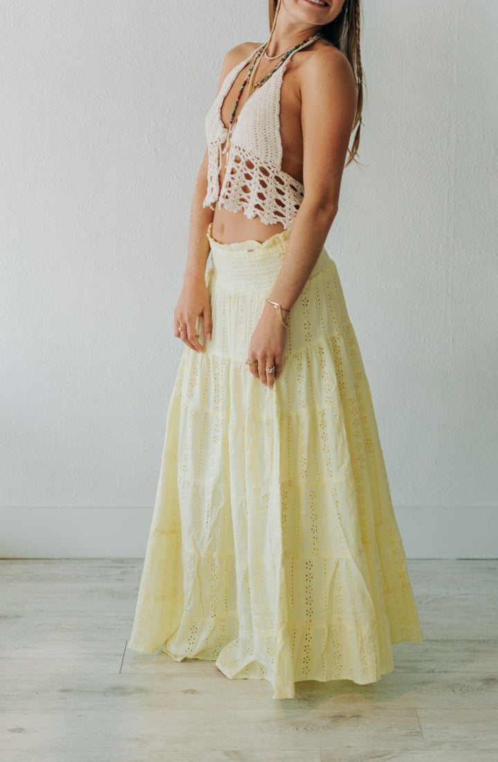 Woman wearing a yellow dress with a white background