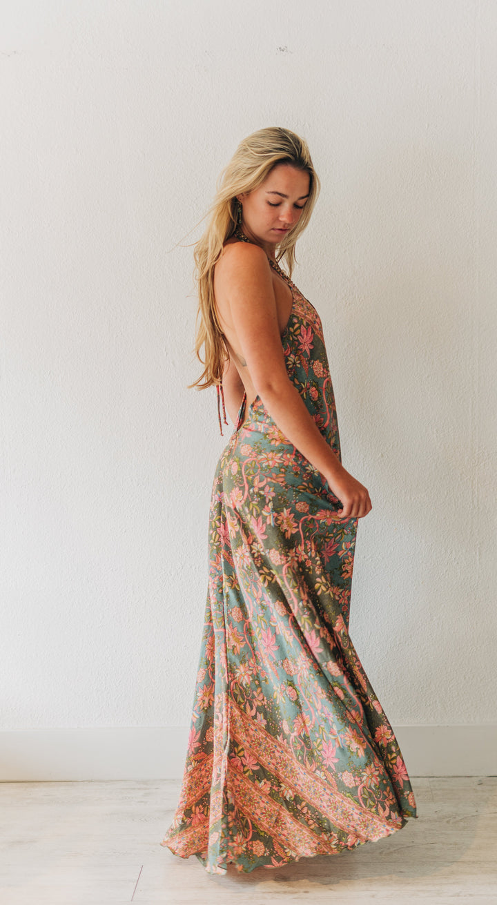 Woman wearing a floral dress in a minimal indoor setting