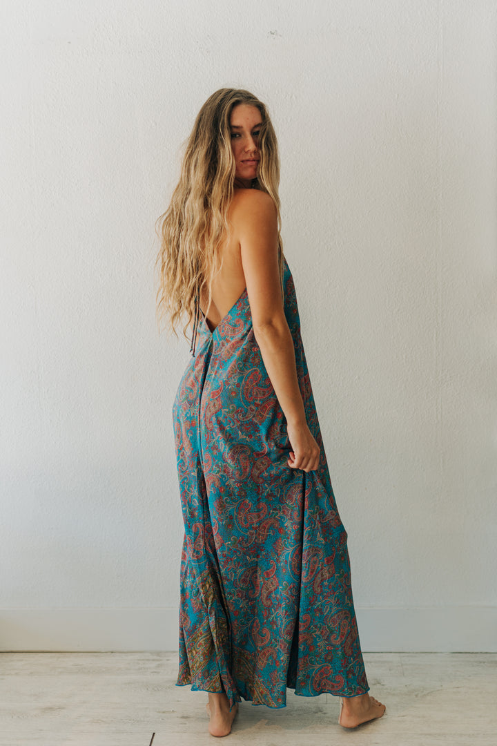 Woman wearing a patterned dress against a plain background