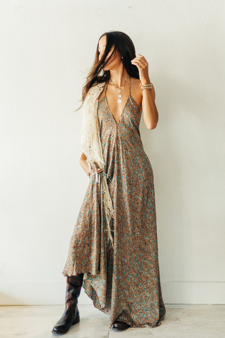 Woman wearing a floral dress with a plain white background